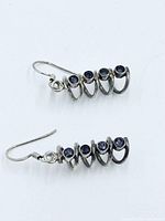 Both earrings laid flat showing front and hook backs