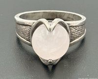 Front view showing rose quartz cabochon and heart-shaped bezel