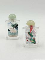 Front view showing rabbit and dragon scenes on two bottles