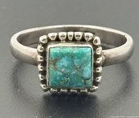 Front view showing turquoise stone and beaded border