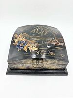 Closed box front perspective showing clasp and painted scene