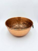 Side view of copper bowl showing exterior condition and hanging ring