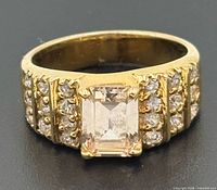 Front view of ring showing center stone and accent rows