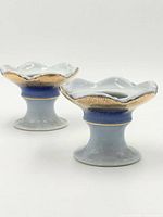 Both candle holders front angled view showing blue gradient and gold gilt rims