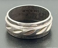 Ring profile showing etched leaf motif and border detail