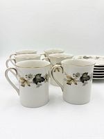 six cups showing pattern and gold rims