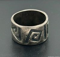 Front view of wide sterling band showing Greek key design