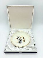 Dish resting in satin-lined box with lid open