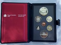 Open case showing obverse designs of all seven coins