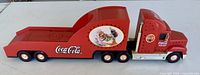 Side view of red Coca-Cola cab and trailer