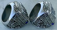 Two rings side view showing CHAMPIONS, WINNIPEG text and CFL logo