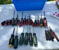 Top view of all screwdrivers laid out with blue bin