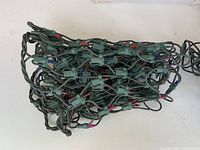 Compact bundle of green‐wire multicolour miniature string lights