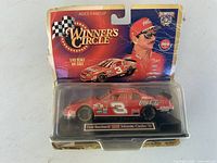 Front of packaged die-cast car showing #3 Coca-Cola Monte Carlo and driver image