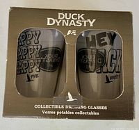 Front of boxed Duck Dynasty glass set showing both glasses through window