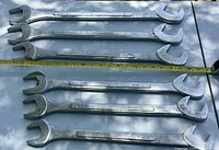 All six large double open-end wrenches laid out with measuring tape