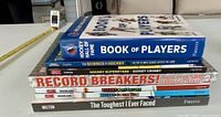 Stack of seven hockey books showing spines