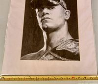 Front view of matted John Cena print with ruler for scale