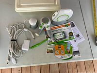 Console, controller, camera, power adapter, cables, game cartridge, literature overview