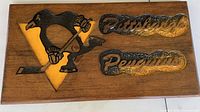 Front view of wooden plaque showing full carving and text