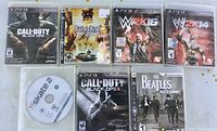 Group shot of all nine PS3 game titles; eight cases plus one loose disc