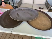 Three large oval platters side by side showing finishes