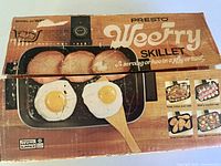 Front of retail box showing WeeFry skillet with eggs and ham