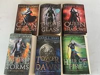 All six paperback novels laid out face-up