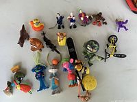 Full group of assorted figures and vehicles scattered on table