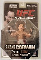 Front view of sealed Shane Carwin action figure in packaging