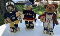 Group shot of the three sports bears on stands