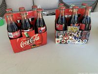 Both six-packs side by side on table