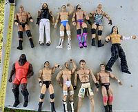 Group shot of all eleven WWE action figures laid out on table