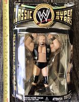 Front view of sealed Stone Cold Steve Austin Series 14 figure in Classic Superstars packaging with measuring tape for scale