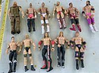 All 11 figures laid out with ruler for scale