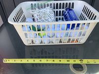 Basket containing golf balls, tees, Dunlop box with measuring tape for scale