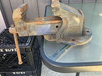 Side view showing full vise, jaws partially open, screw handle and mounting base