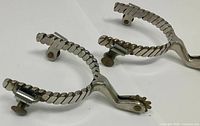 Top view of both spurs showing twisted shank and rowels