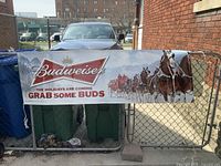 Full view of Budweiser banner displayed on fence