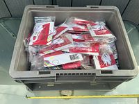 Top view of grey crate filled with packaged audio splitters