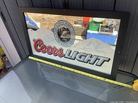 Front view of Coors Light framed mirror on table