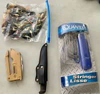 All items together: bag of lures, multi tool, fillet knife with sheath, packaged Quantum stringer