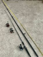 All three rods laid out with two reels showing overall length and components