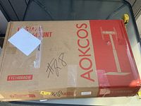 Sealed box showing AOKCOS branding and stand illustration