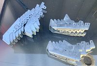 Stacks of galvanized steel joist hangers showing quantity and design