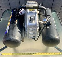 Top view of entire compressor showing twin tanks, motor housing, handle and on/off switch
