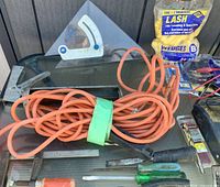 overview of extension cord, angle square, wedges bag, hand tools on table
