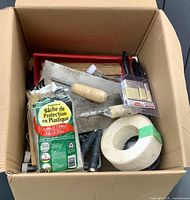 Top view of box showing assorted painting tools and supplies