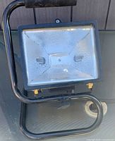 Front view showing glass lens and steel stand