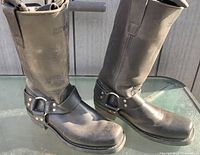 Side view of both boots showing harness straps and general wear